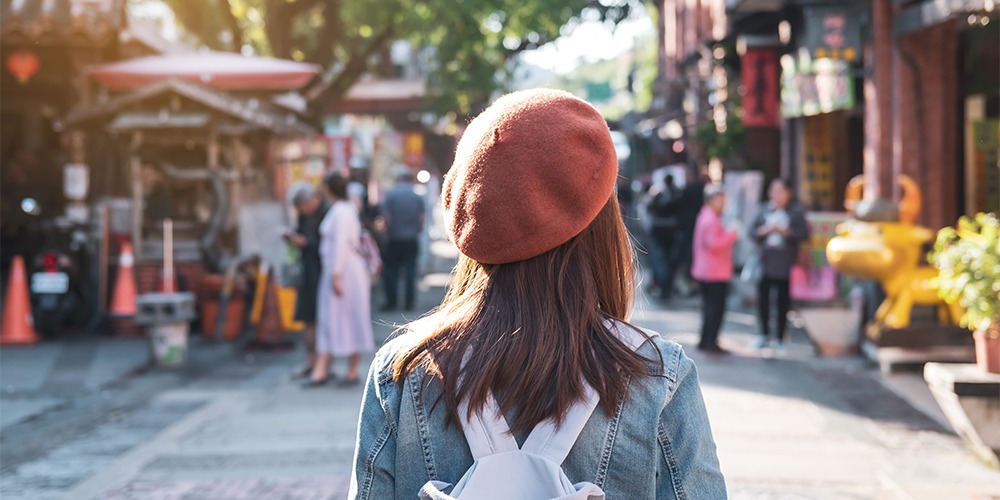 young-woman-traveler-walking-in-the-shopping-stree-2021-10-06-09-52-59-utc